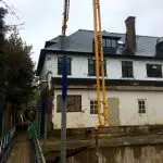 CIFA 42m concrete boom pump - pumping over the top of a house - back view